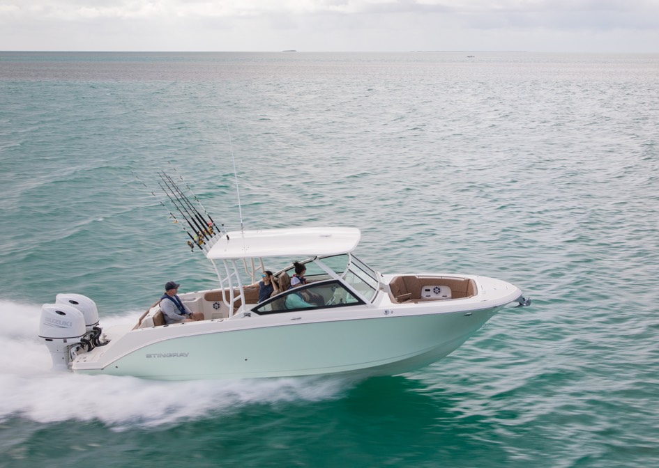 The boat is equipped with twin outboard engines, a hardtop with rod holders.