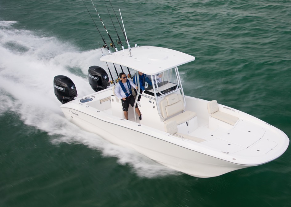 small white boat anchored with a DF250AP - DUAL outboards sailing on a fresh water